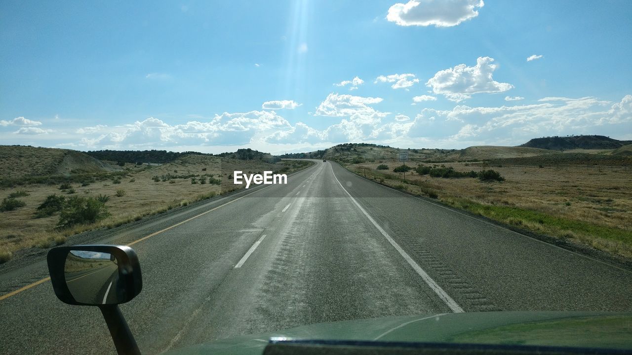 ROAD SEEN FROM CAR WINDSHIELD
