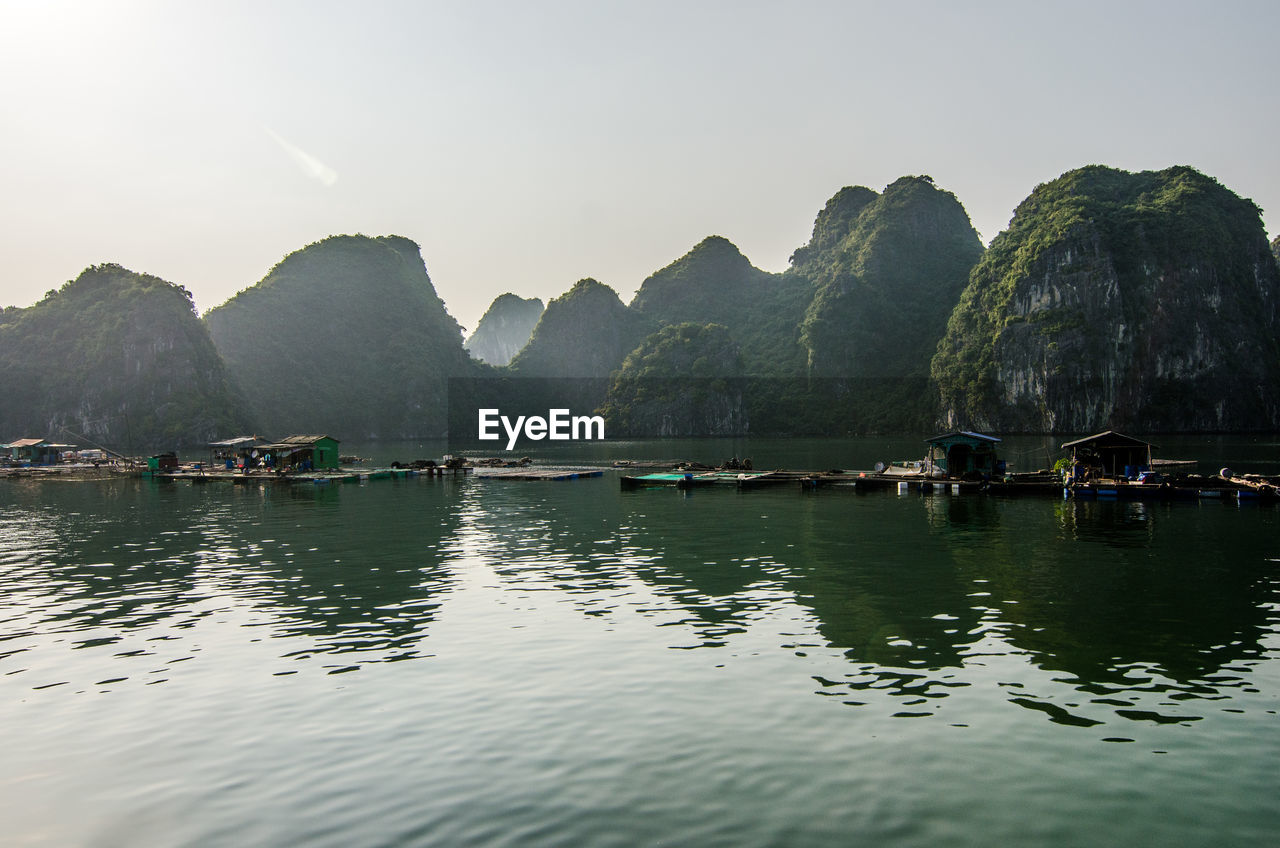 Scenic view of river and mountains against clear sky