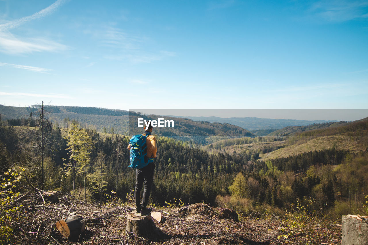 rear view of man walking on mountain