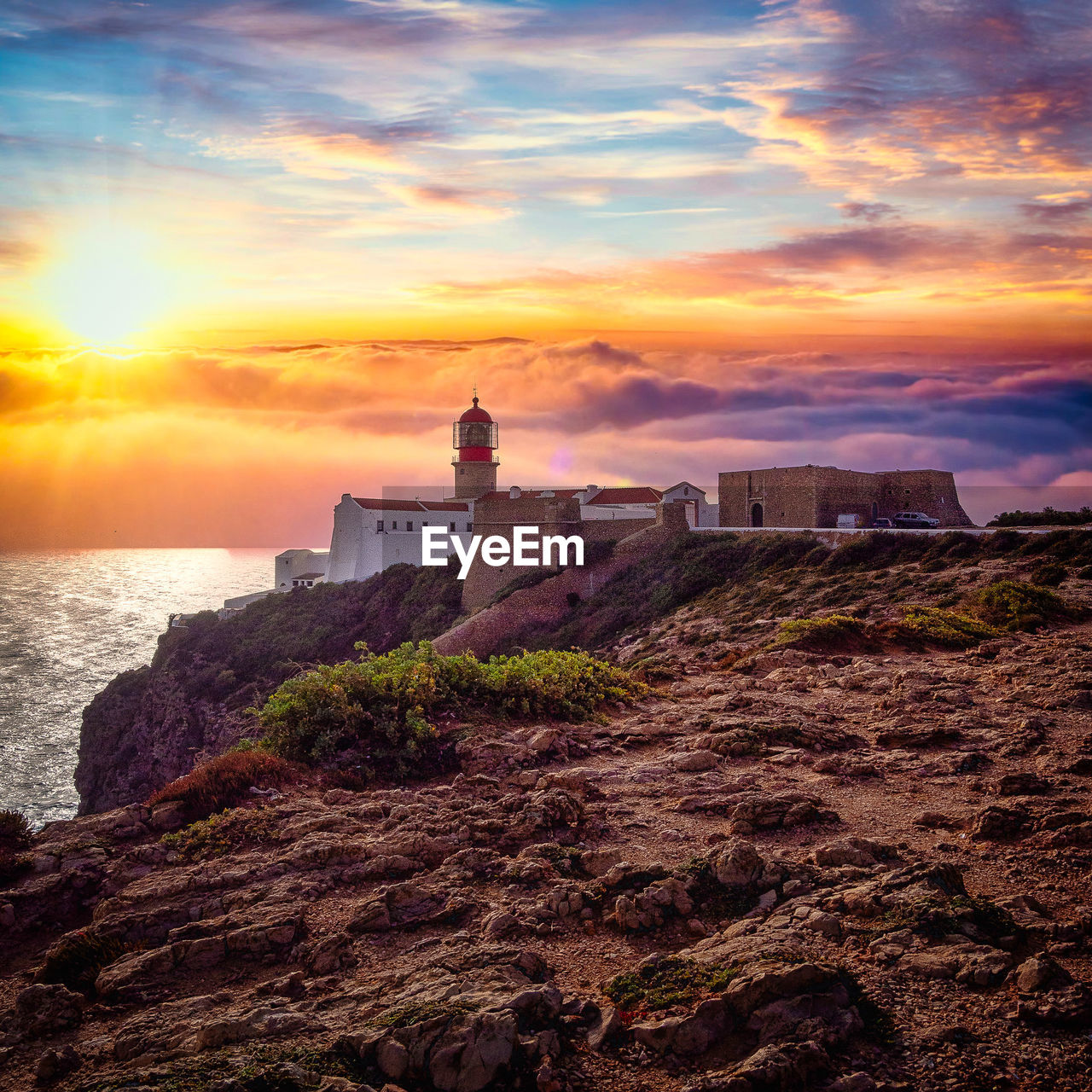 LIGHTHOUSE ON BEACH DURING SUNSET
