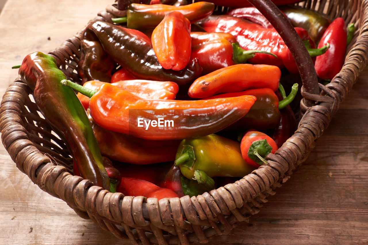 Close-up of chili peppers in basket on table
