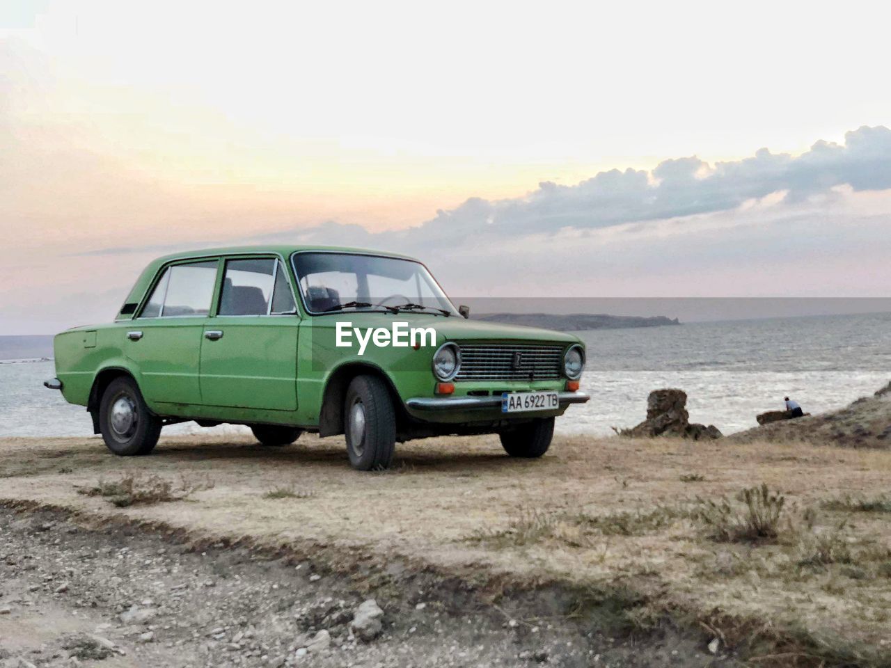 VINTAGE CAR ON BEACH AGAINST SKY