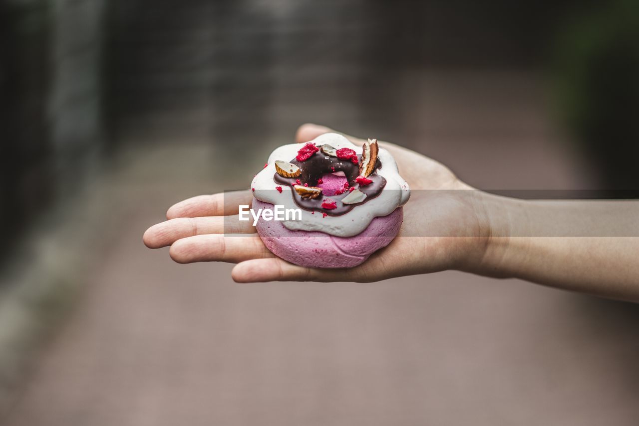 Cropped image of hand holding dessert