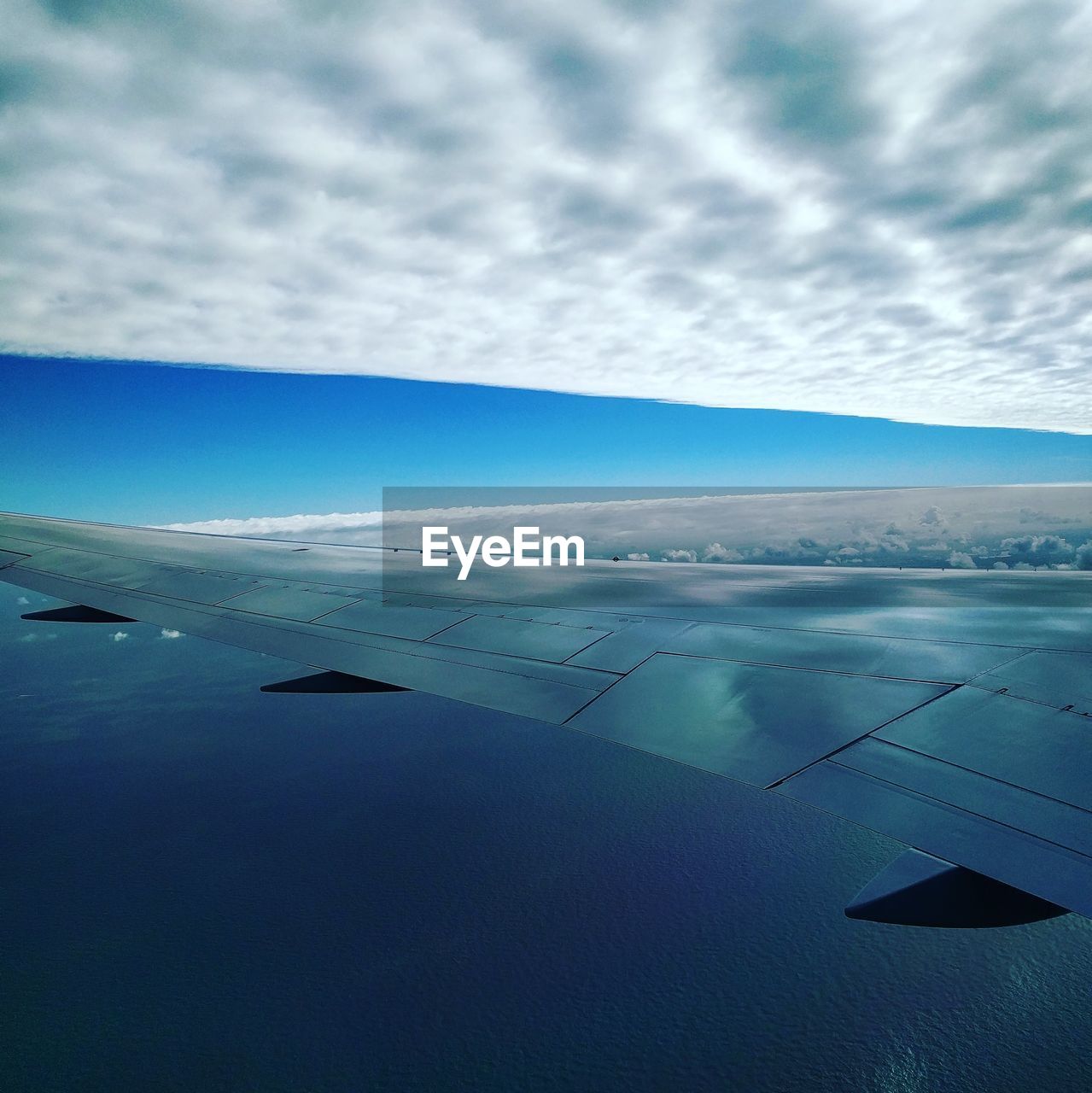 SCENIC VIEW OF AIRPLANE WING AGAINST SKY