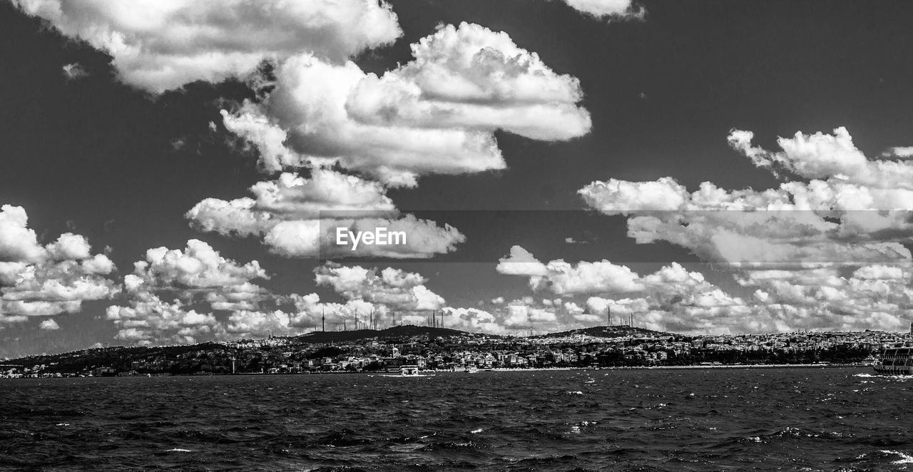 View of calm sea below cloudy sky