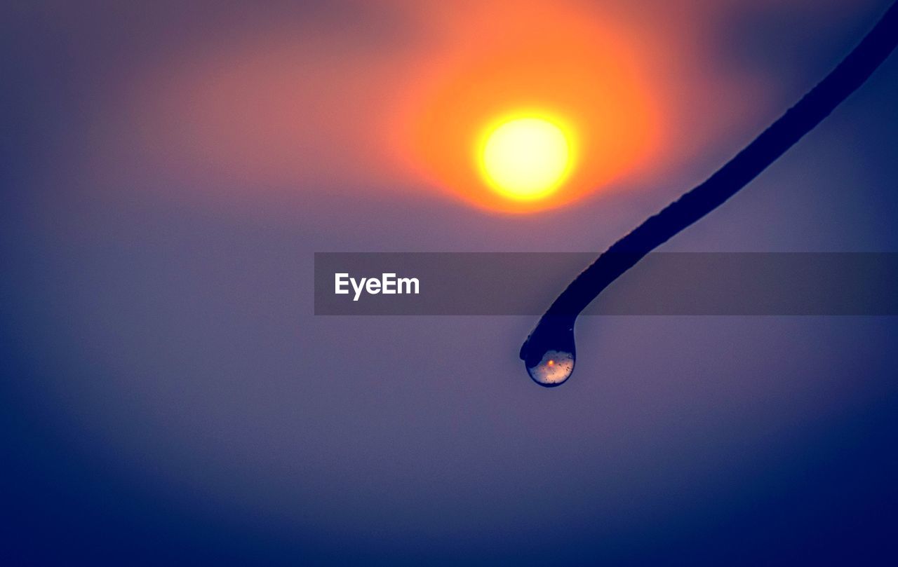 CLOSE-UP OF WATER DROPS ON ORANGE SUN