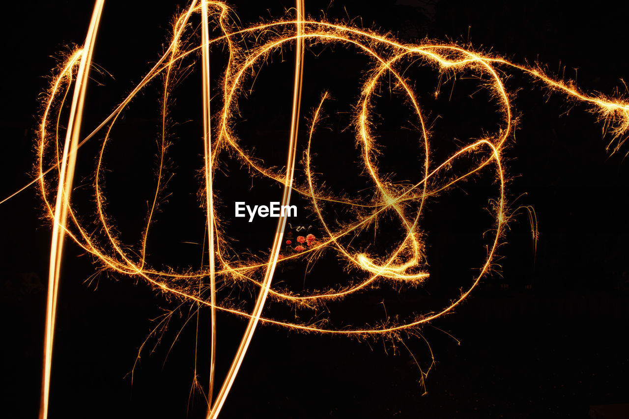 Low angle view of light painting against sky at night