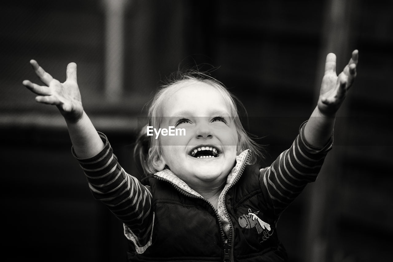 PORTRAIT OF CUTE GIRL WITH ARMS OUTSTRETCHED