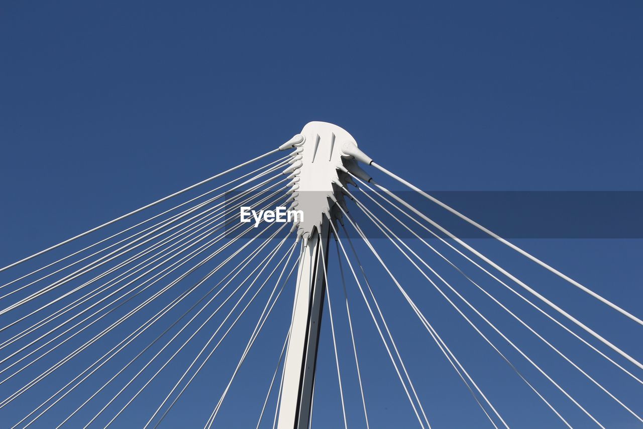 LOW ANGLE VIEW OF SUSPENSION BRIDGE AGAINST SKY