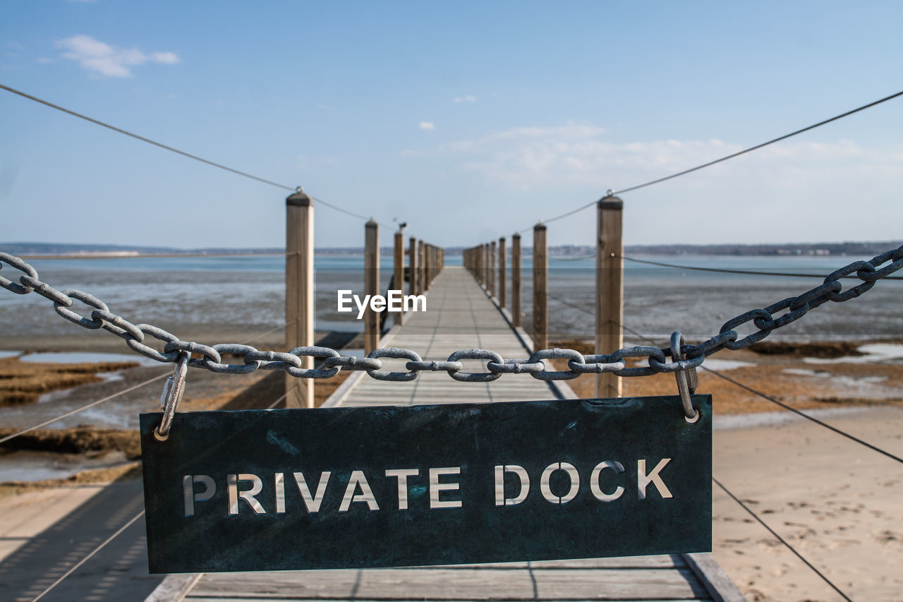 Private dock text hanging on chain at pier