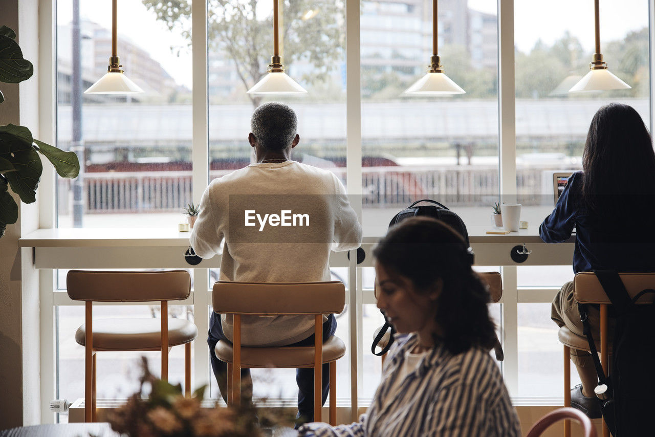 Male and female business professionals working together at coworking office