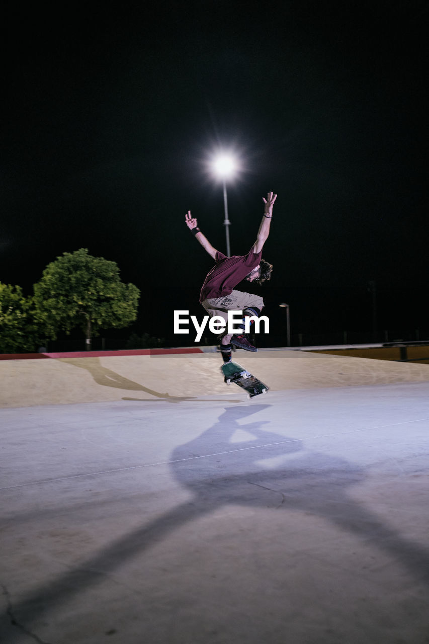 Young white man jumping on his skateboard