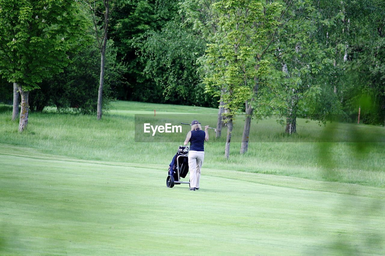 Rear view of woman on golf course