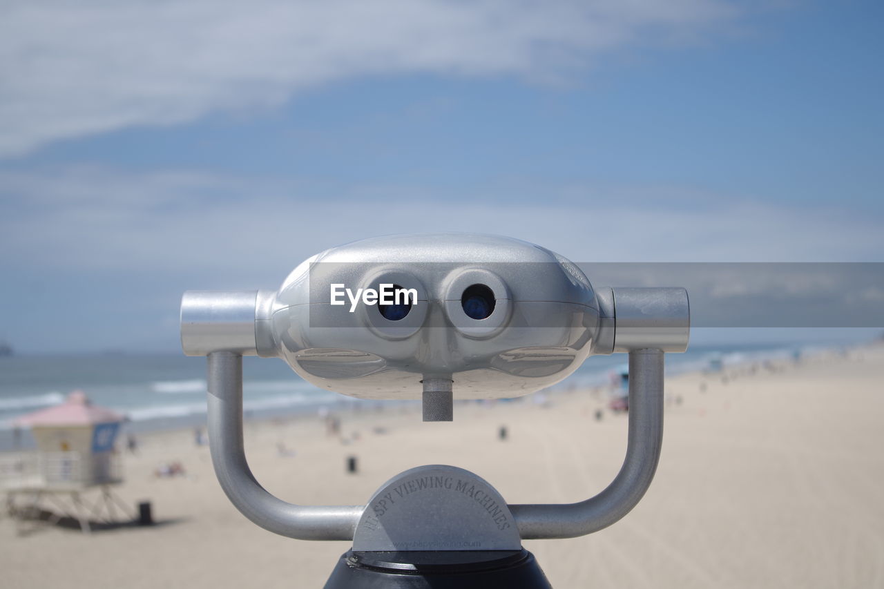 Close-up of coin-operated binoculars against sky