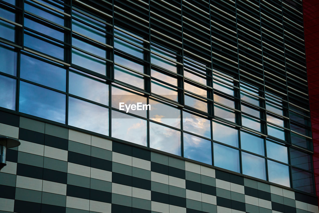 Office building with sky reflection in window. part of house facade. modern city architecture