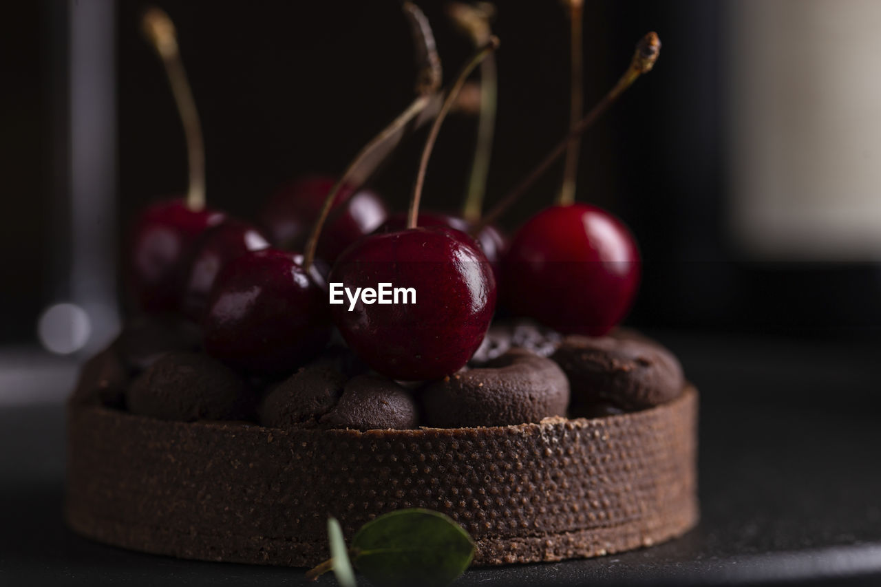 Chocolate tart with ganache decorated with fresh cherry