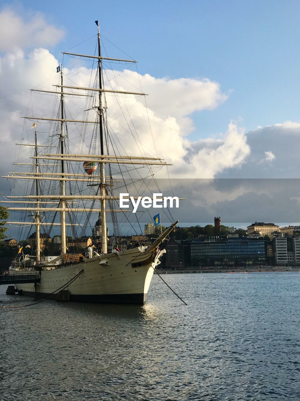 SAILBOAT MOORED ON SEA AGAINST SKY