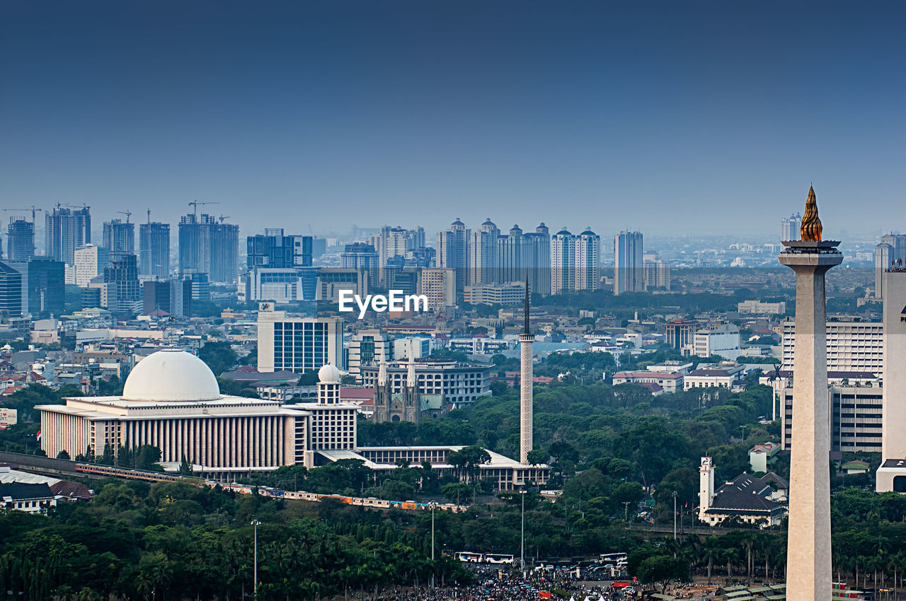 Modern buildings in city against clear sky