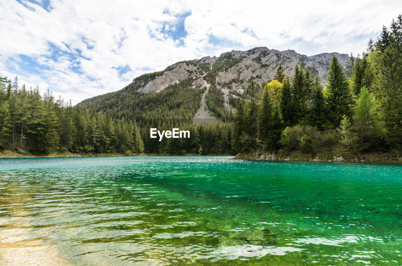 Scenic view of lake and mountains against sky