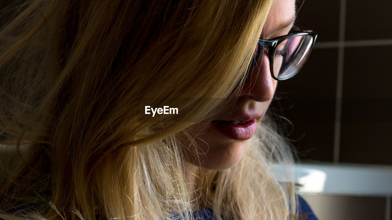 Close-up of blond woman wearing eyeglasses