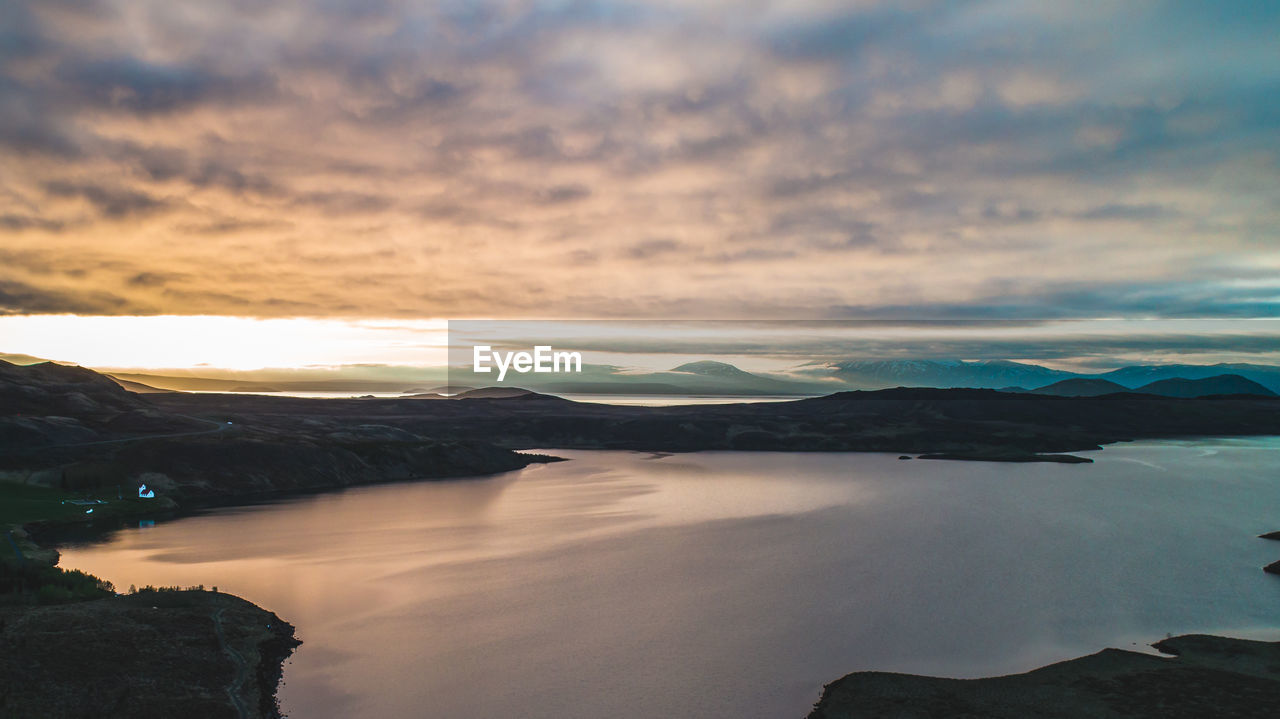 Scenic view of lake against sky during sunset