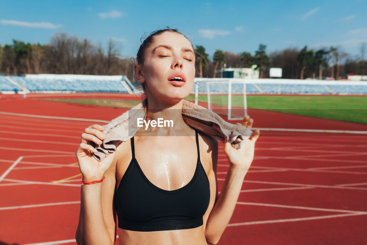 Female athlete standing on running track