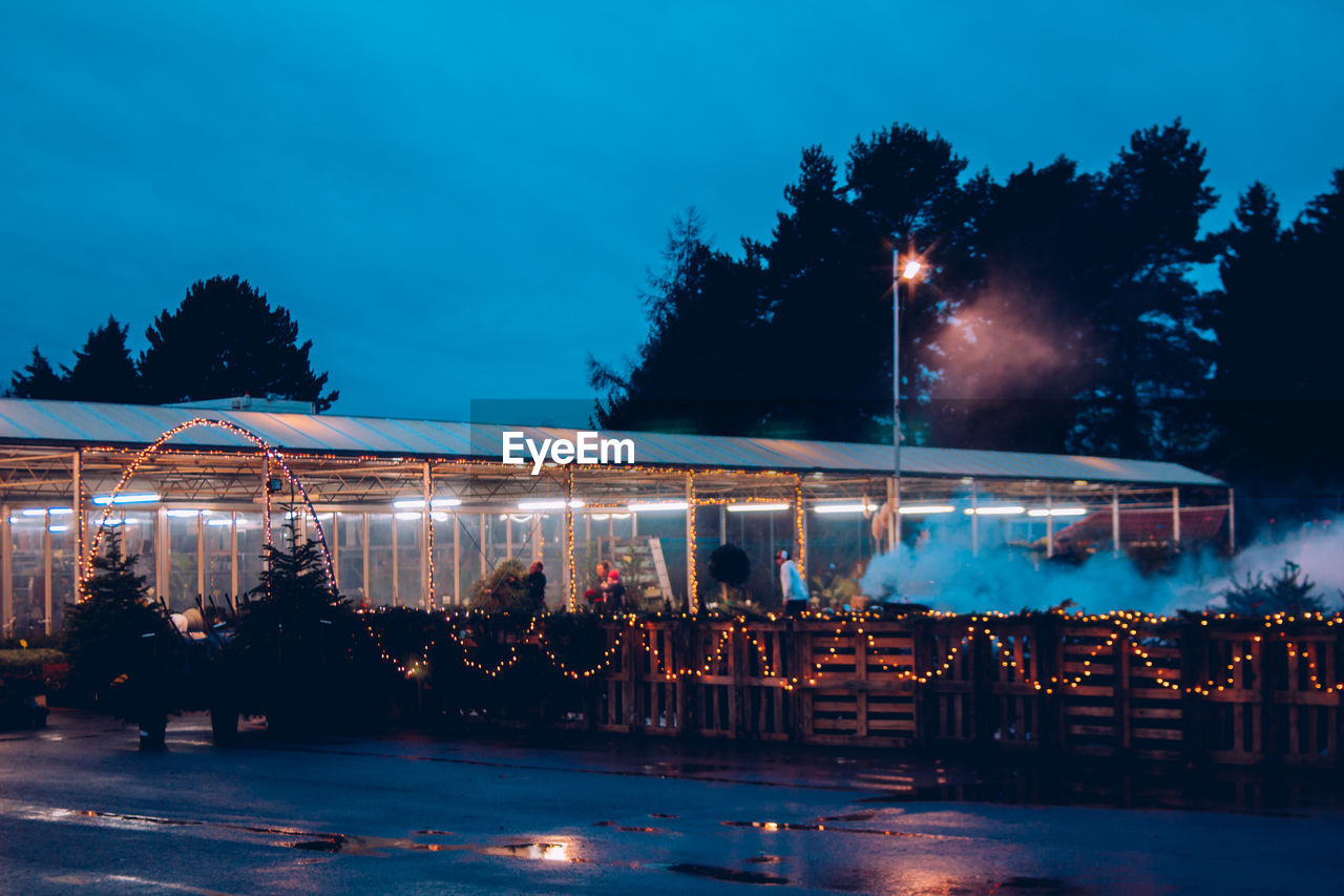 People in illuminated city at night