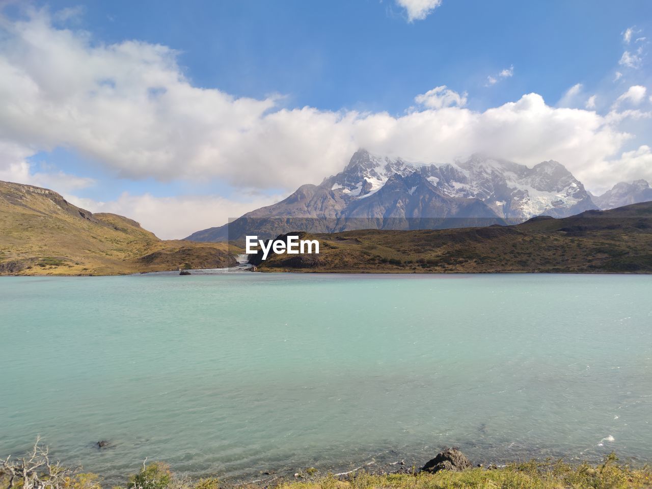 mountain, water, scenics - nature, environment, lake, landscape, sky, mountain range, beauty in nature, cloud, nature, land, travel destinations, reservoir, body of water, highland, travel, snow, tranquil scene, tranquility, no people, mountain peak, snowcapped mountain, cold temperature, tourism, wilderness, day, outdoors, non-urban scene, winter, blue, plant, idyllic, vacation, trip, beach, holiday