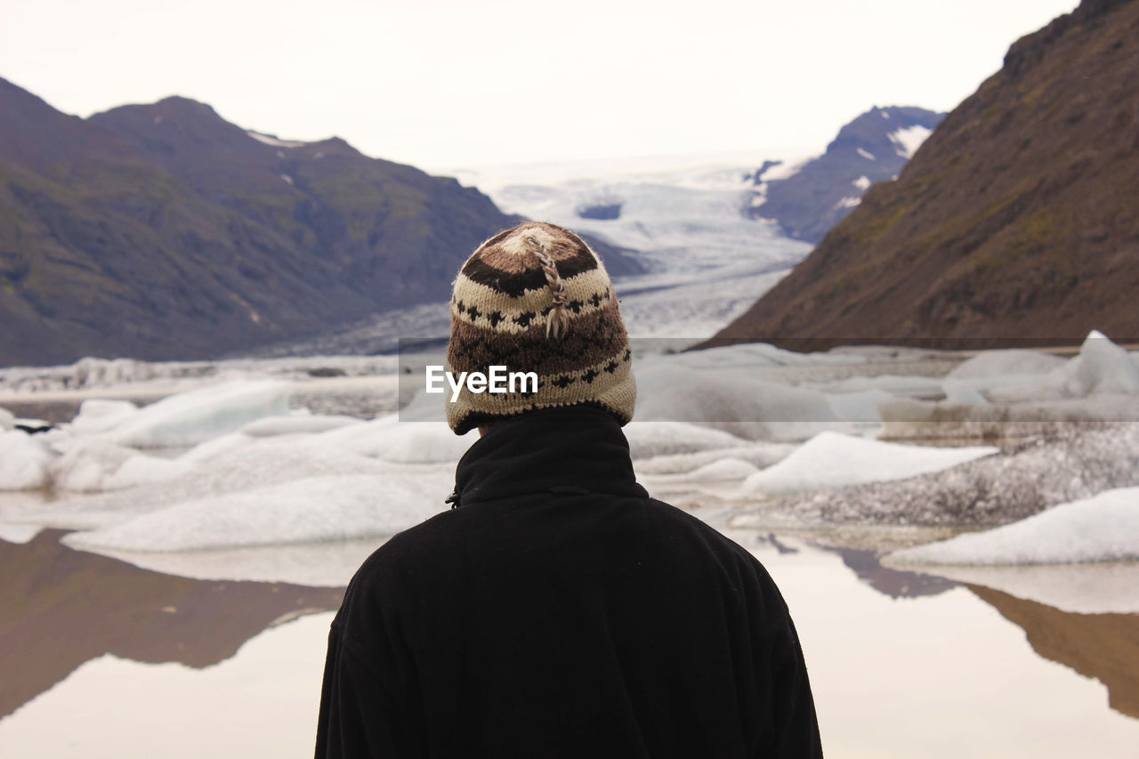 Rear view of tourist standing on mountain