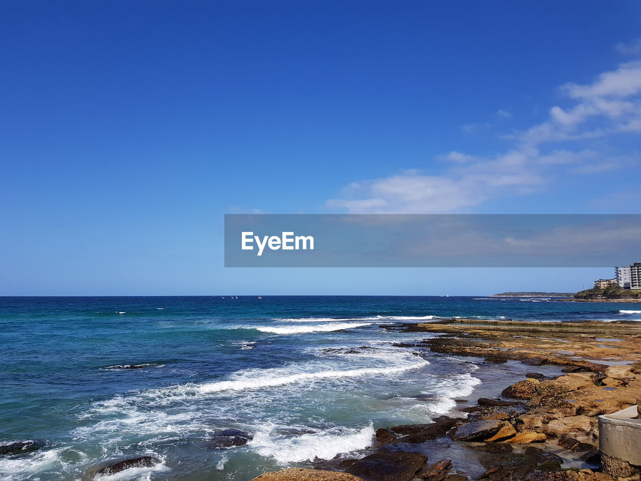 Scenic view of sea against blue sky