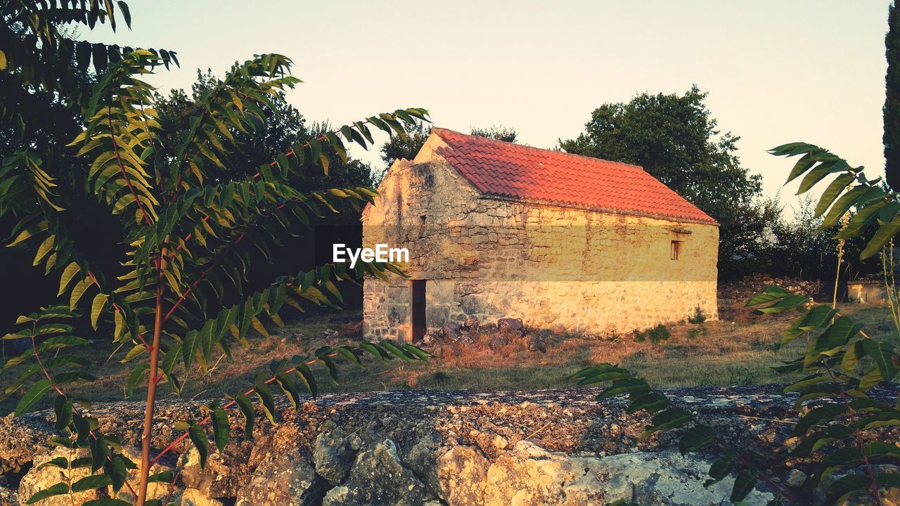 Old building on field against sky