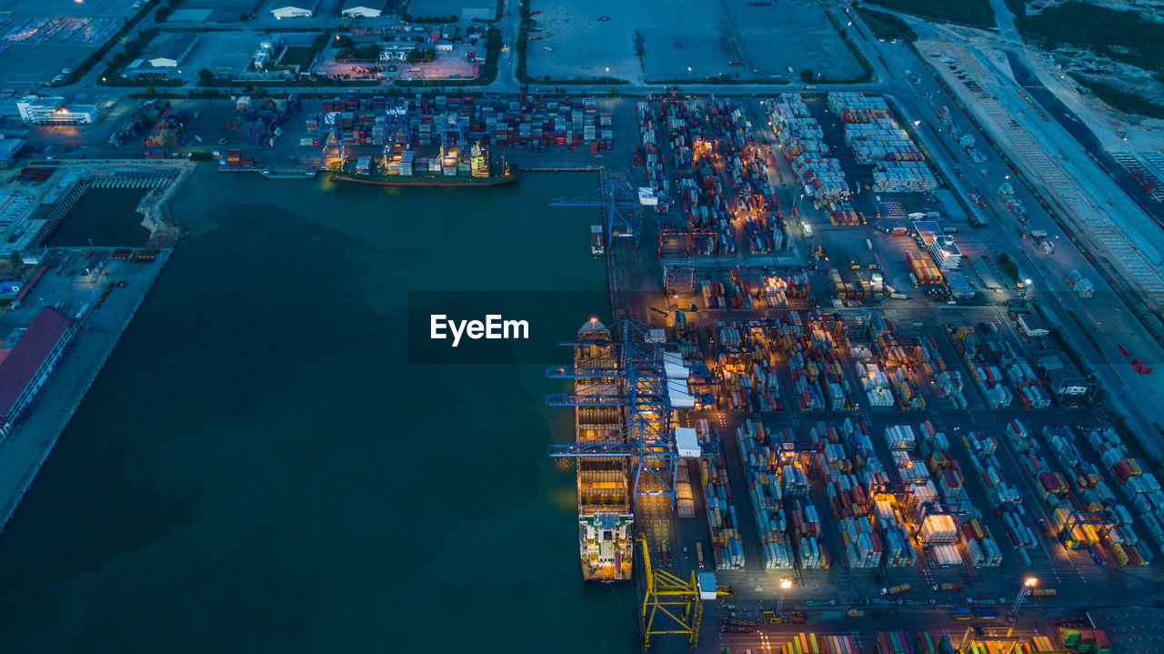 High angle view of illuminated container ship at commercial dock