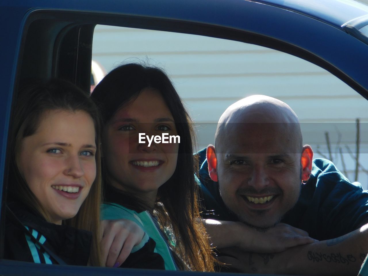 Portrait of smiling friends in car