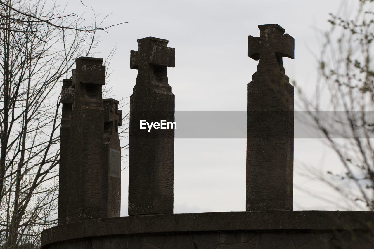 Low angle view of stone crosses