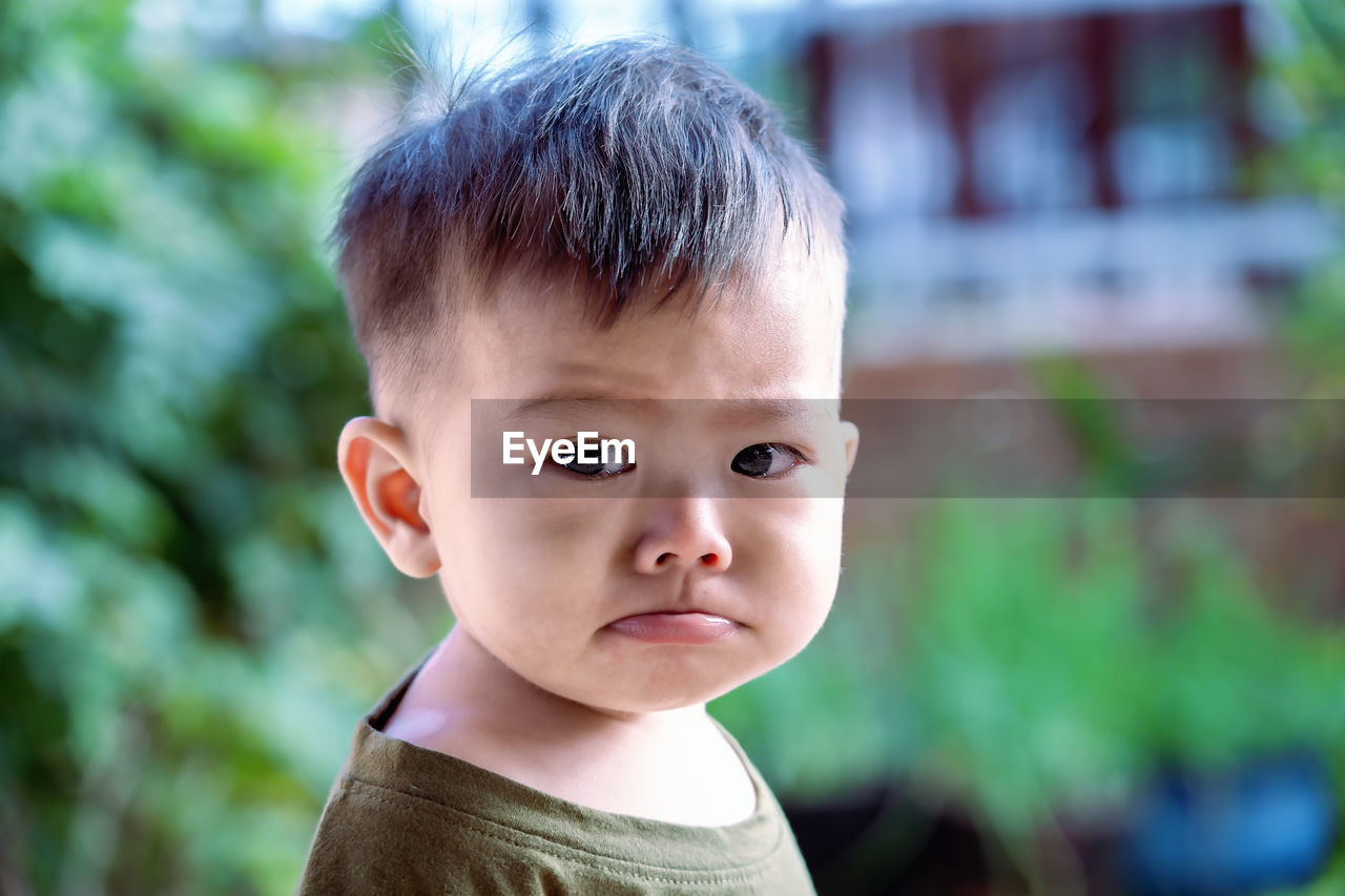 Close up of asian child boy's face with tears. upset crying and mad little toddler boy. 