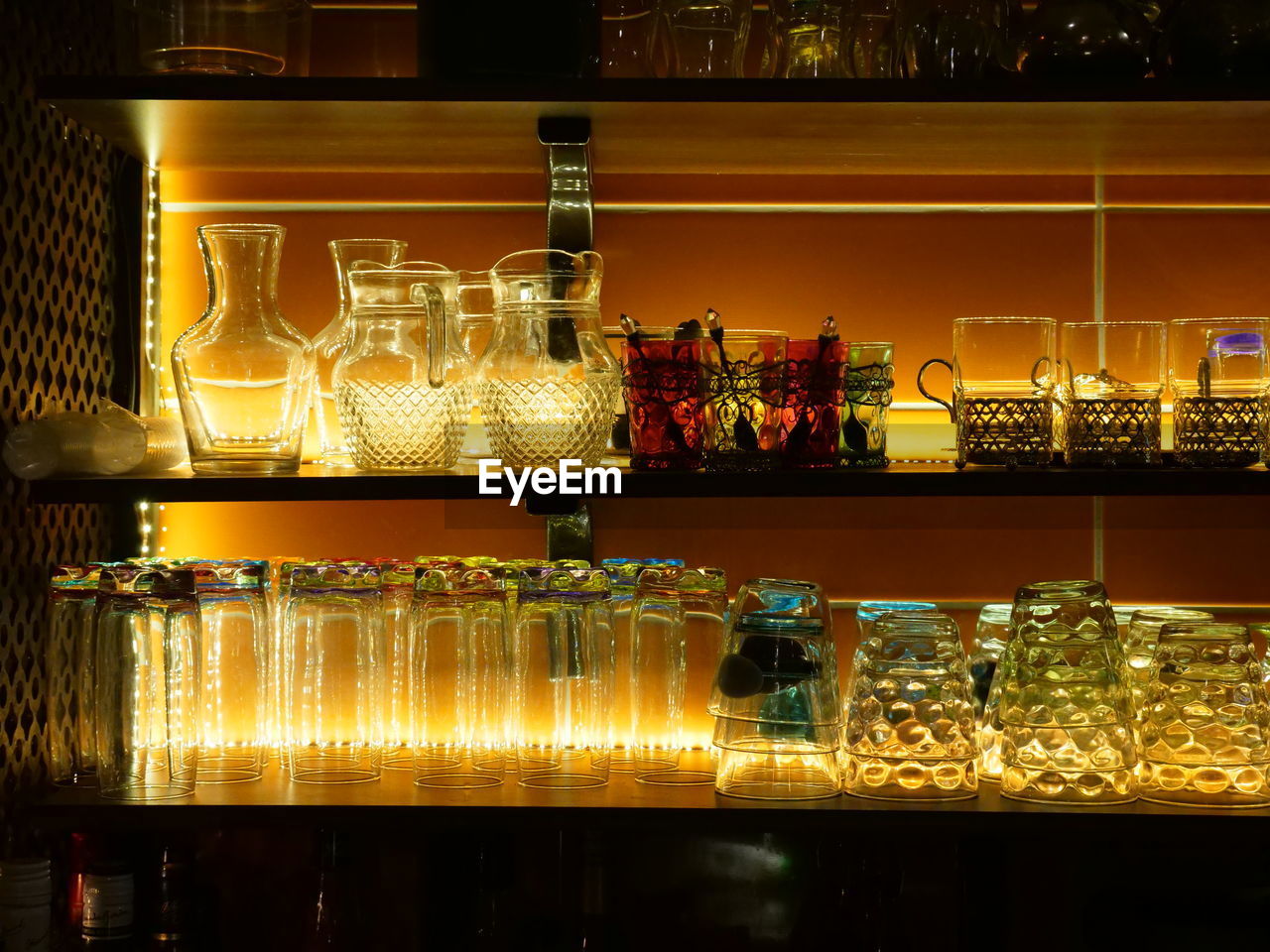 Glass of bottles on display at bar