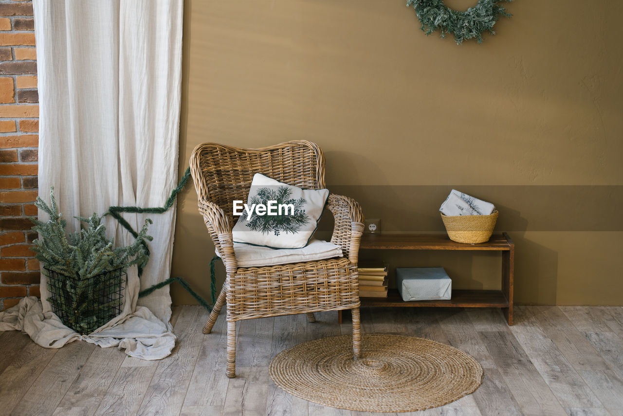 Wicker armchair in living room with christmas scandinavian minimalist decor in a country house