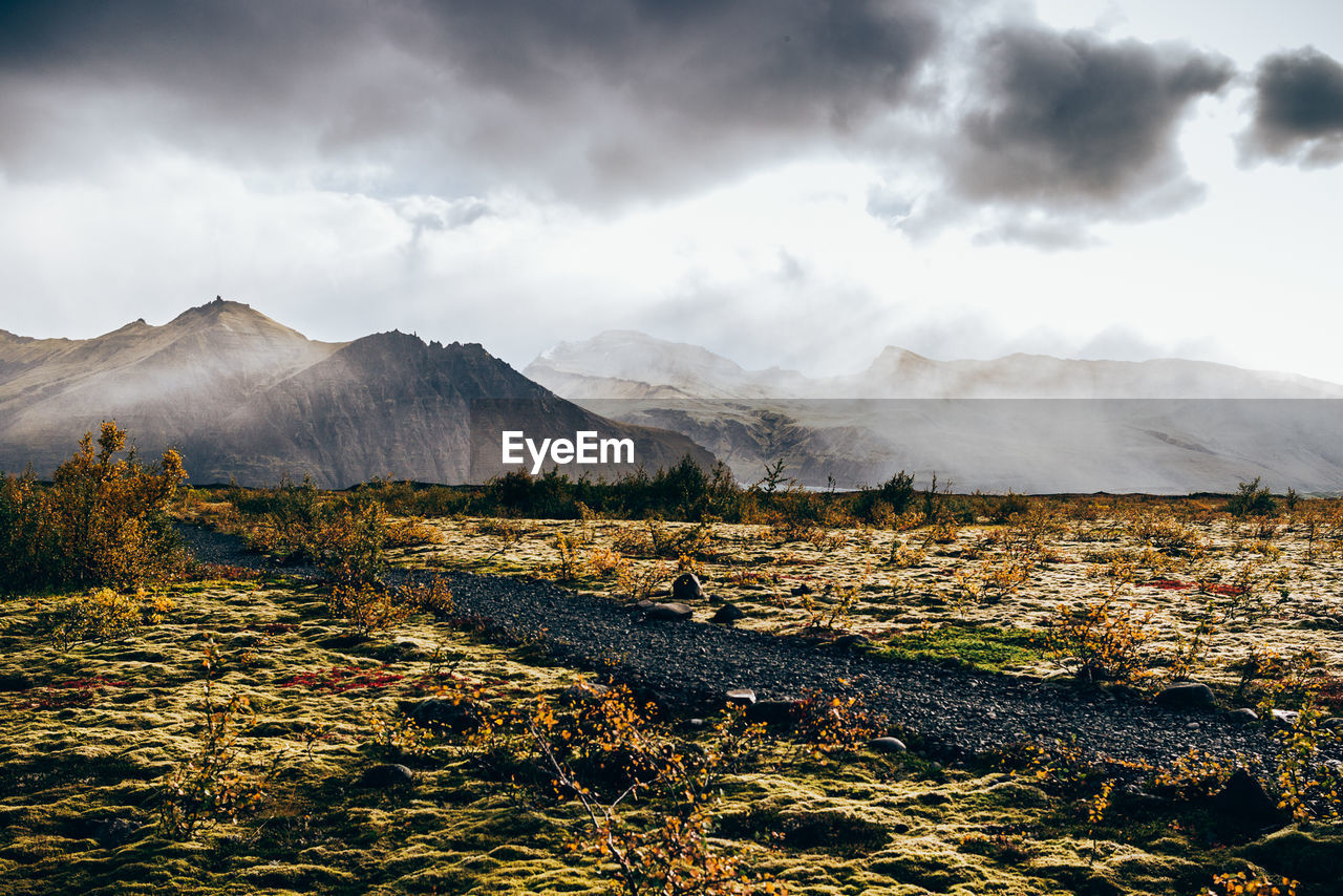 Scenic view of landscape against cloudy sky