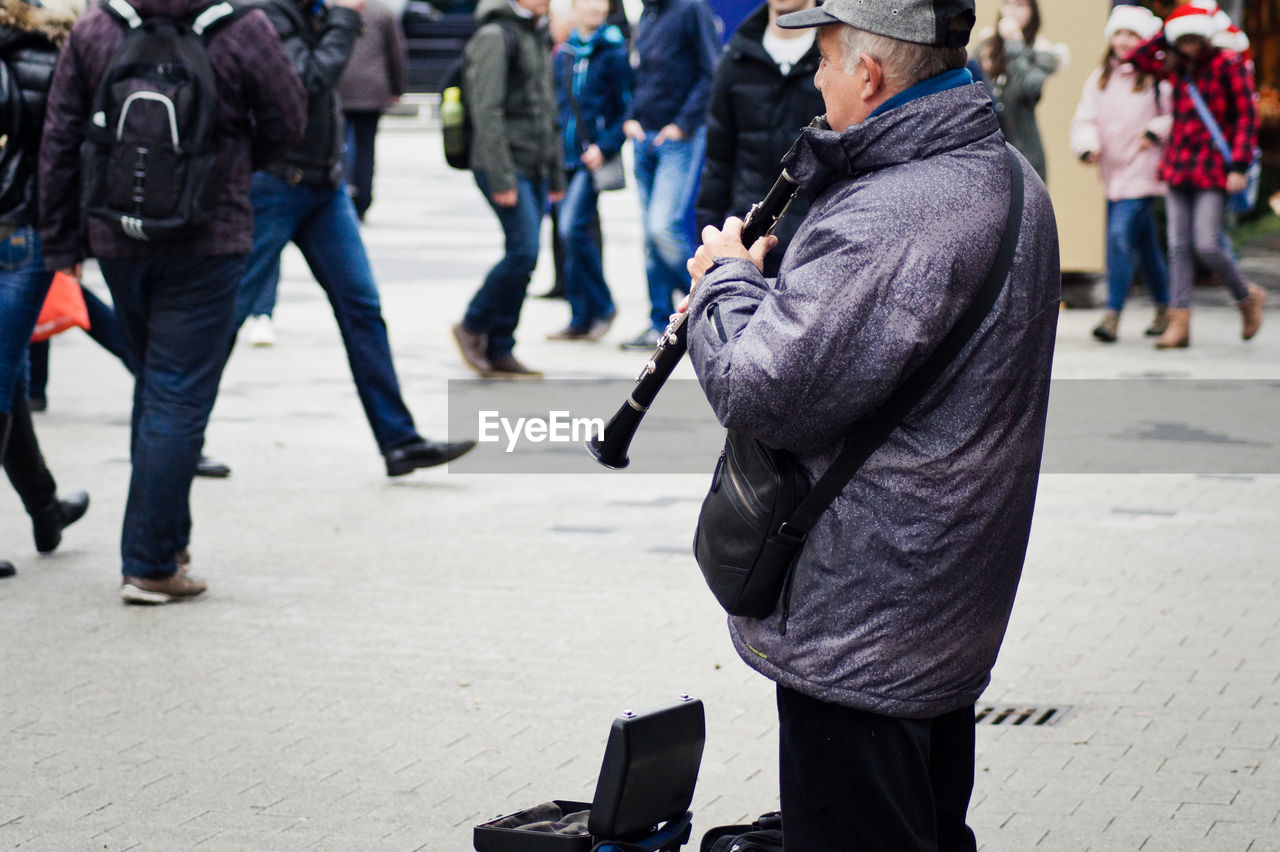 Musician playing clarinet on street