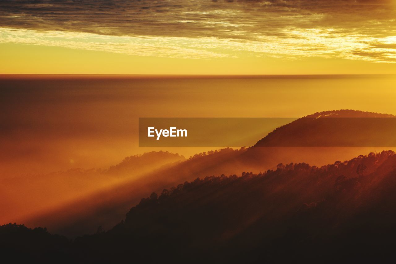 Scenic view of dramatic sky during sunset