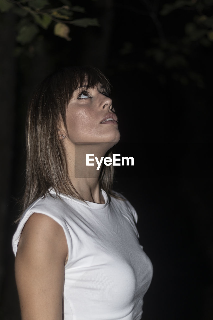 one person, female, portrait, women, portrait photography, adult, white, hairstyle, young adult, photo shoot, long hair, person, black, looking, waist up, contemplation, side view, emotion, standing, human face, casual clothing, human hair, looking away, fashion, teenager, black background, headshot, brown hair, child, profile view, indoors, lifestyles, clothing, nature, serious, human eye