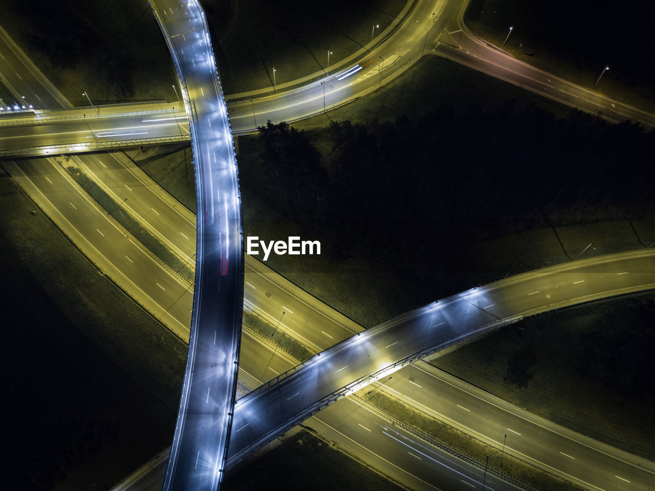 LIGHT TRAILS ON ROAD AGAINST SKY