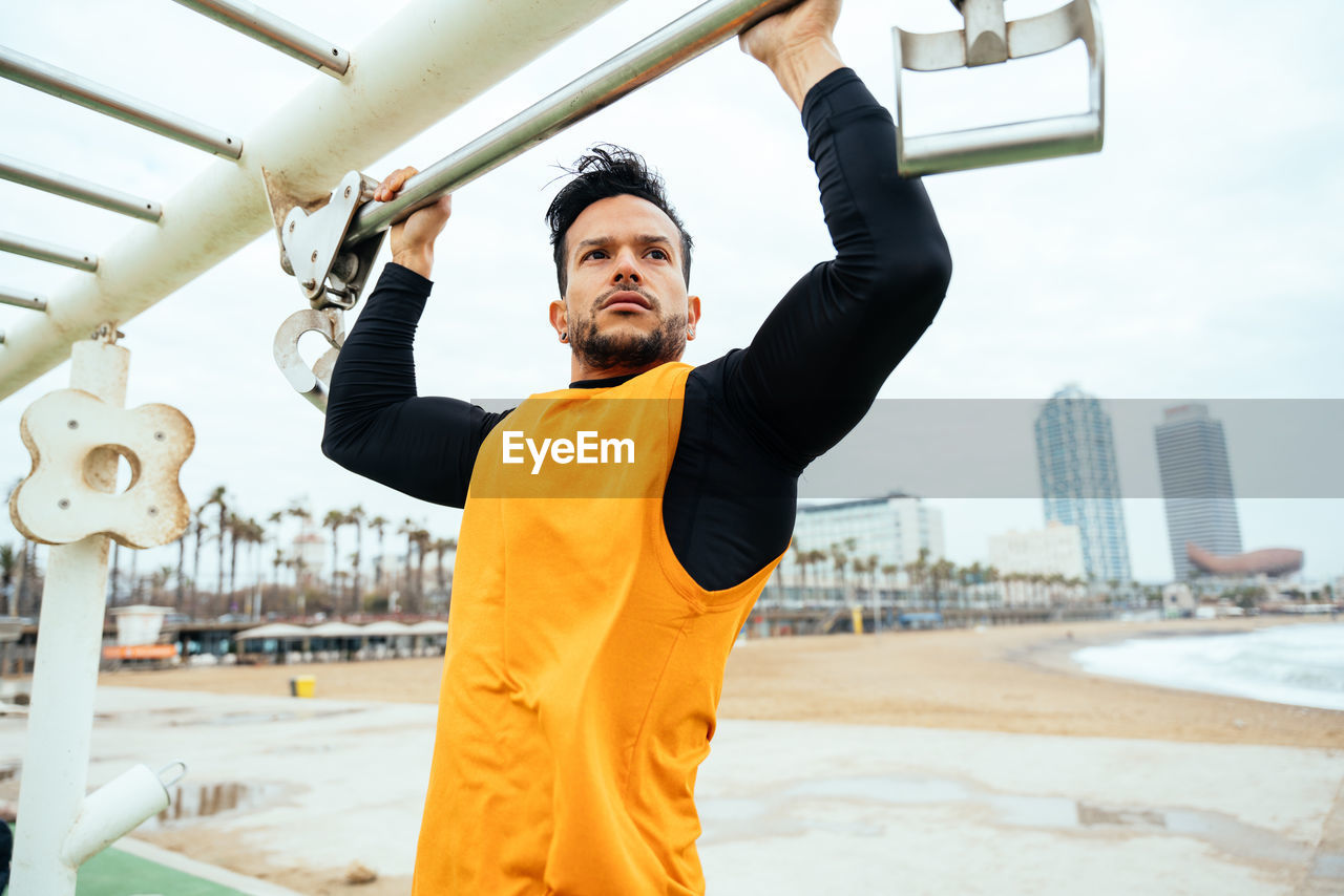 Portrait of young man exercising in city