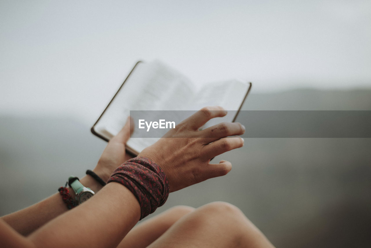 Cropped image of woman holding book at grand canyon national park