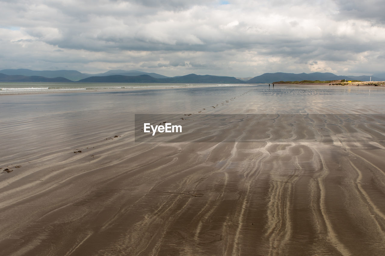 View of beach against cloudy sky