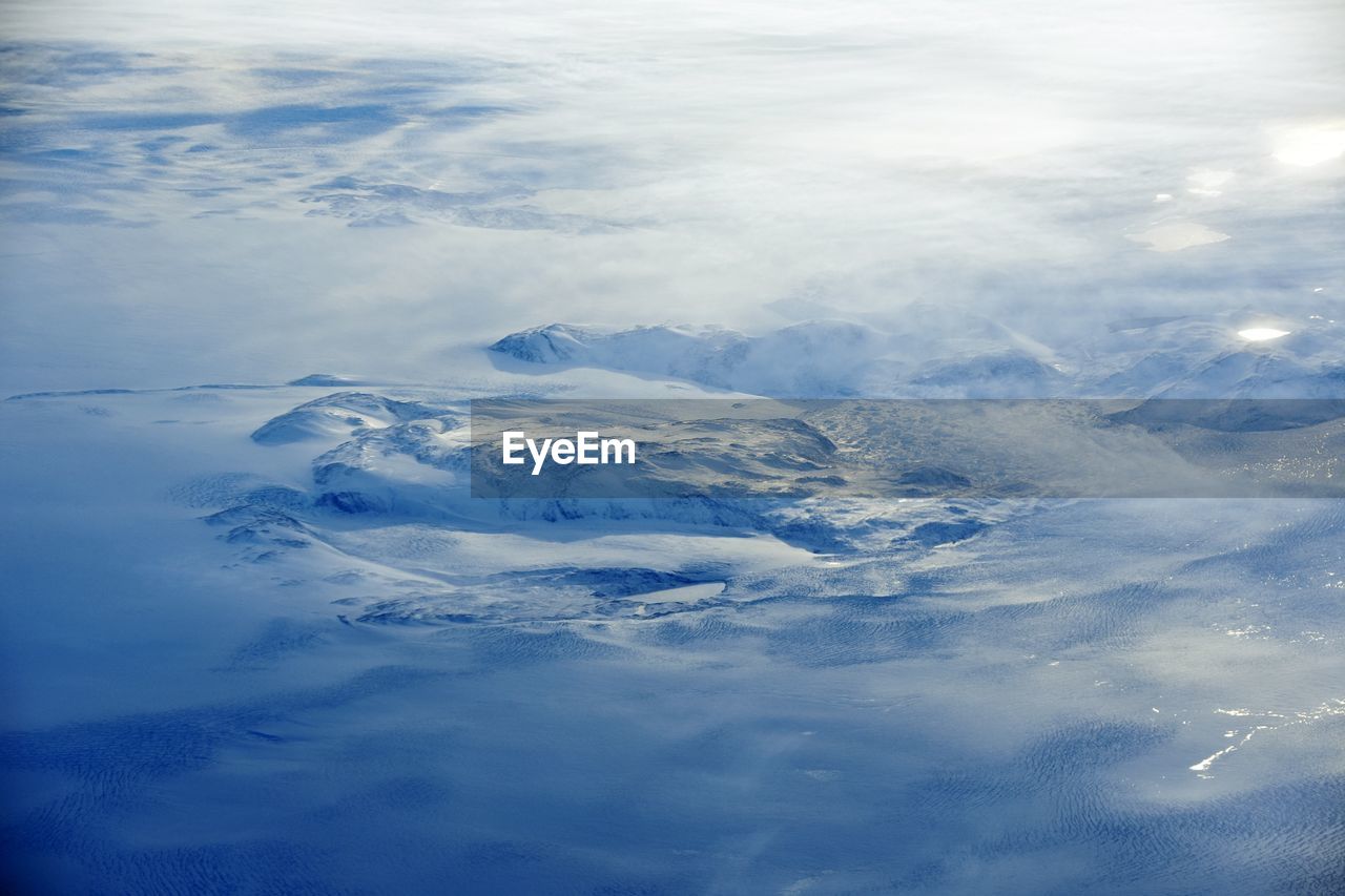 AERIAL VIEW OF SNOW COVERED MOUNTAIN