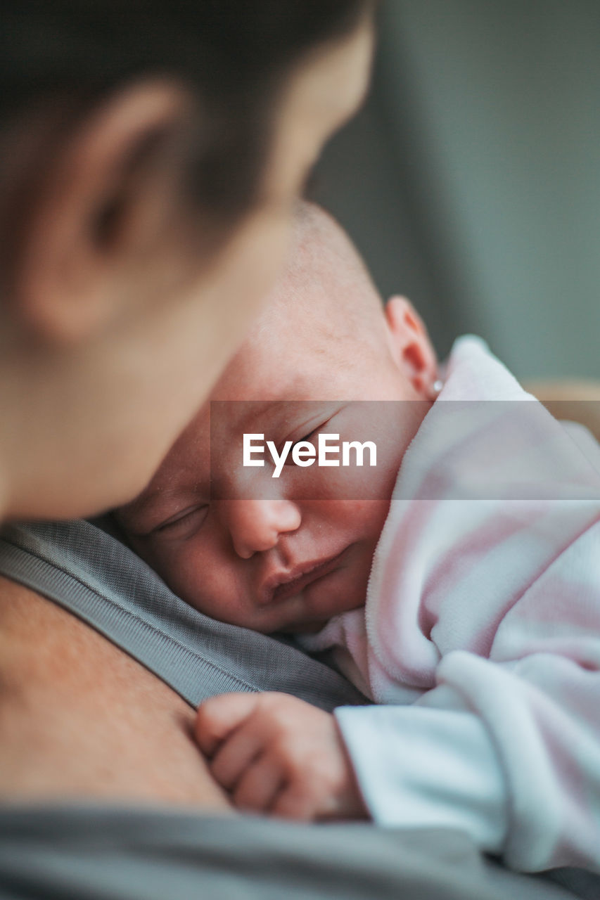 Close-up of baby sleeping at home