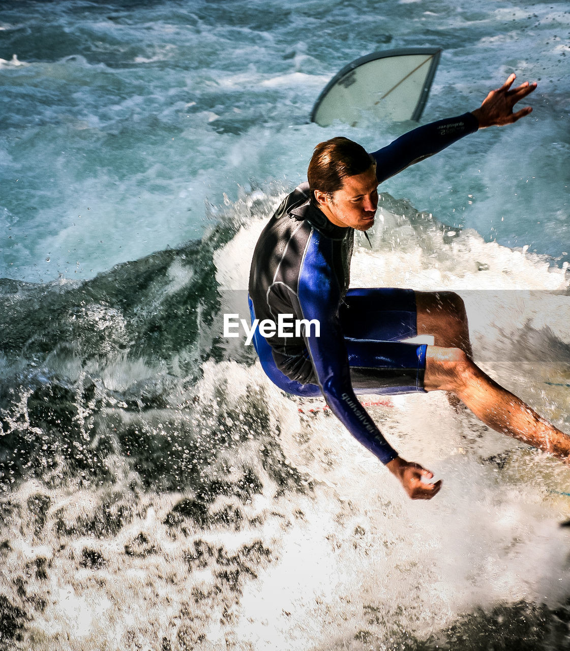 YOUNG WOMAN JUMPING IN WATER