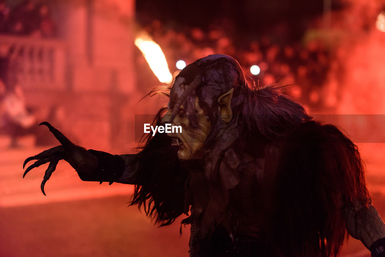 Man with spooky make-up performing at traditional event