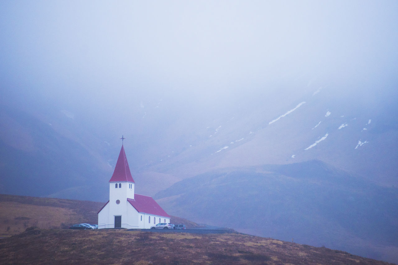 TRADITIONAL WINDMILL ON MOUNTAIN AGAINST SKY